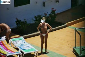 Girls sunbathe topless near the pool. Thumb 23