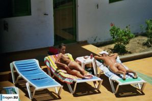 Girls sunbathe topless near the pool. Thumb 36