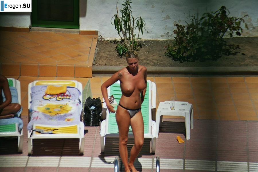 Girls sunbathe topless near the pool. Part 2. Photo 11