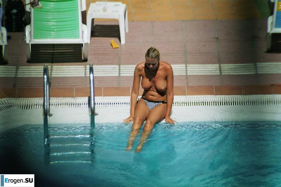 Girls sunbathe topless near the pool. Part 2. Photo 13