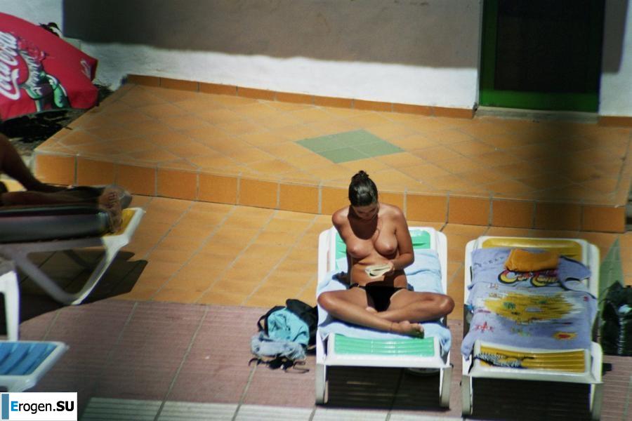 Girls sunbathe topless near the pool. Part 2. Photo 14