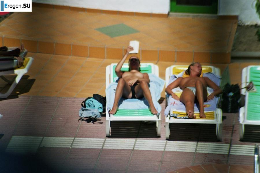 Girls sunbathe topless near the pool. Part 2. Photo 16