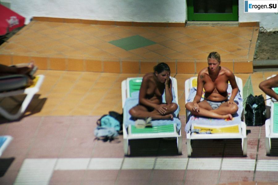 Girls sunbathe topless near the pool. Part 2. Photo 17