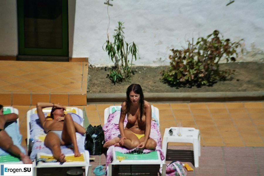Girls sunbathe topless near the pool. Part 2. Photo 4