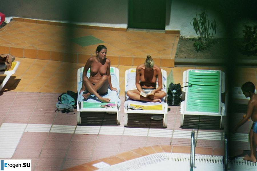 Girls sunbathe topless near the pool. Part 2. Photo 6