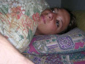 A tanned brunette shines her tits in the morning in bed. Thumb 12