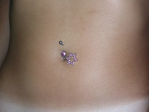 A tanned brunette shines her tits in the morning in bed. Thumb 24