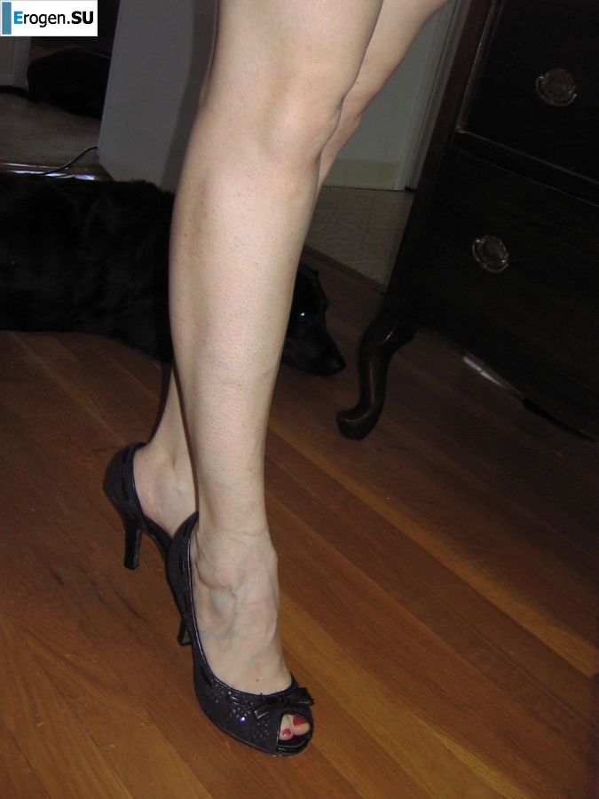 A mature woman posing in a transparent dress in front of a man. Photo 28