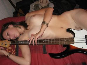 A naked chick poses with a guitar, and a guy licks her. Thumb 8