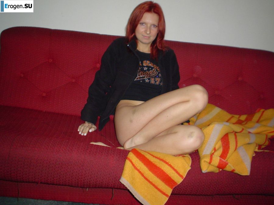 The red-haired beauty with a shaved pussy poses in one jacket. Photo 14
