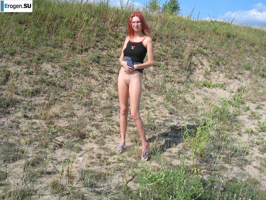 The red-haired beauty with a shaved pussy poses in one jacket. Photo 27