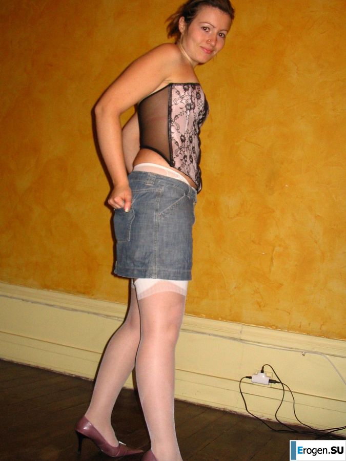 A young woman shows her ass and legs in white stockings. Photo 23