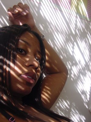 The mulatto pulls her boobs, and then spreads her legs. Thumb 28