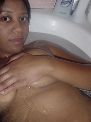 The mulatto pulls her boobs, and then spreads her legs. Thumb 39