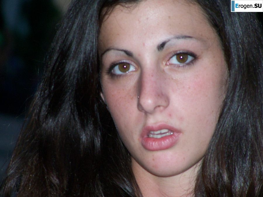 A brunette in a short skirt poses on white sheets. Photo 3