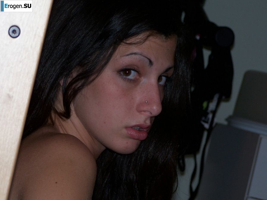 A brunette in a short skirt poses on white sheets. Photo 4