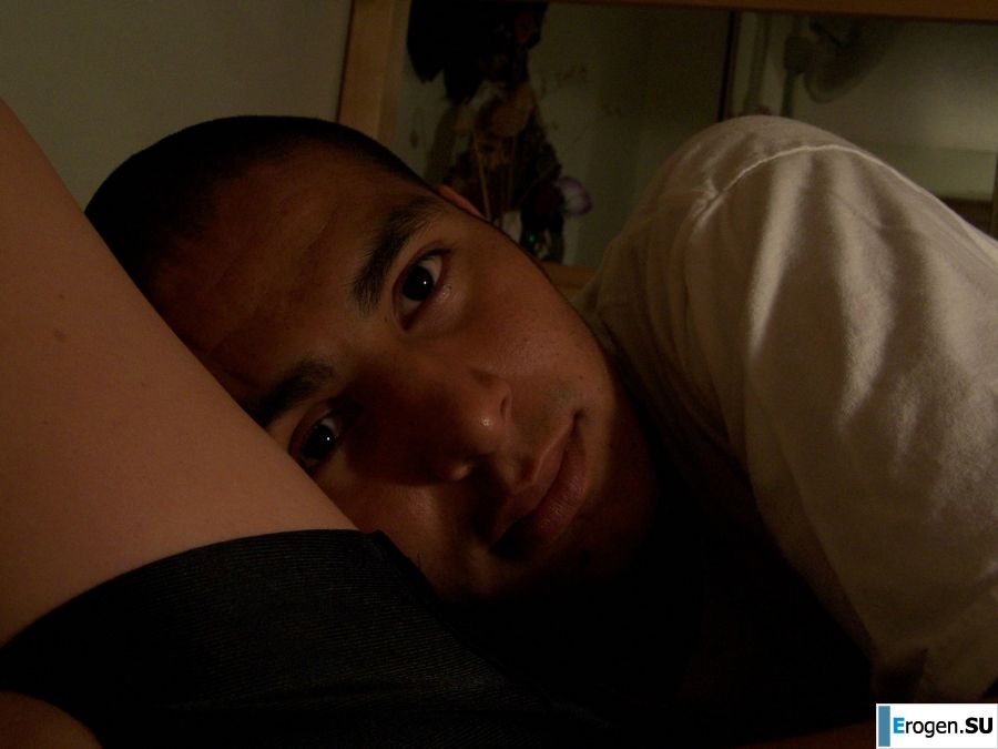 A brunette in a short skirt poses on white sheets. Photo 42