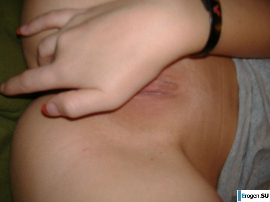 A young girl pleases herself with a finger and a pink vibrator. Photo 6