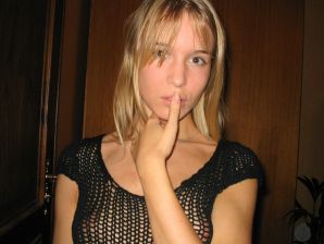 A young blonde in stockings spreads her legs on the sofa. Thumb 1